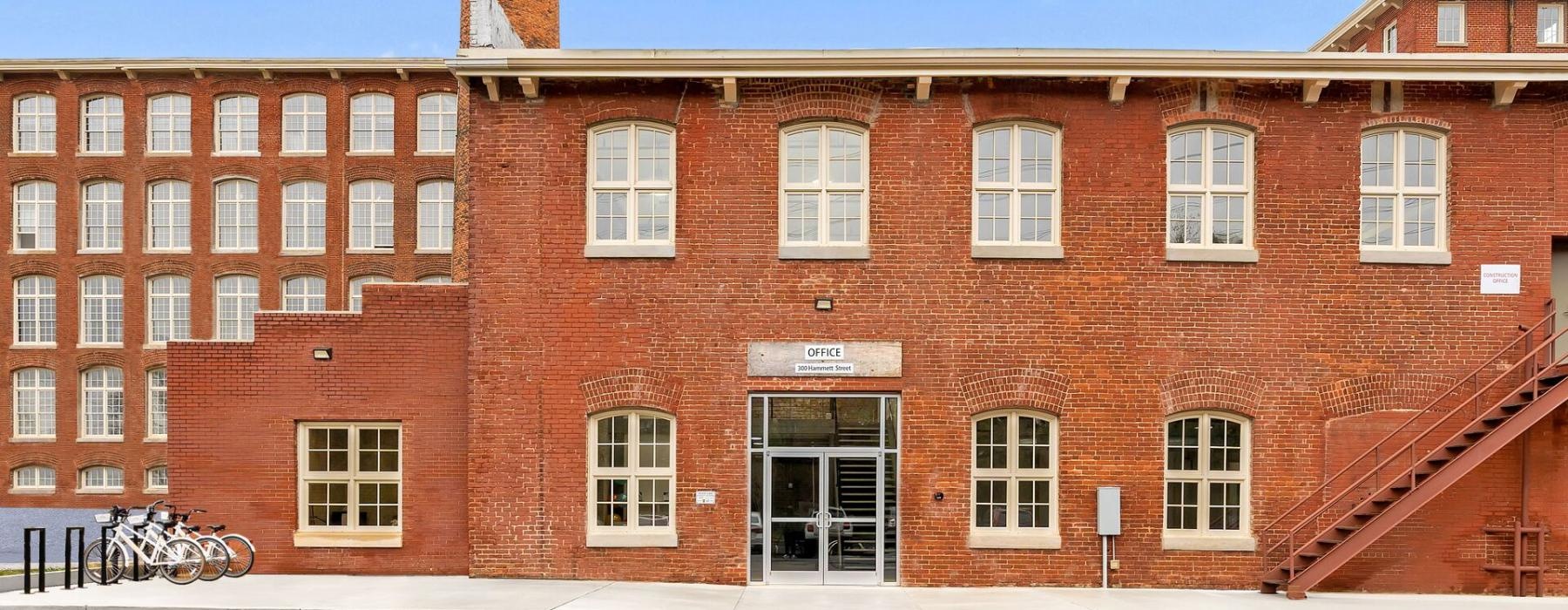 a brick building with bikes parked in front of it